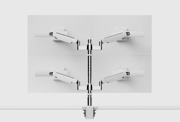 White Humanscale M/Flex M2 Pro quad monitor arm system supporting four white monitors on a white background, featuring dual brackets with horizontal sliders and a desk clamp mount