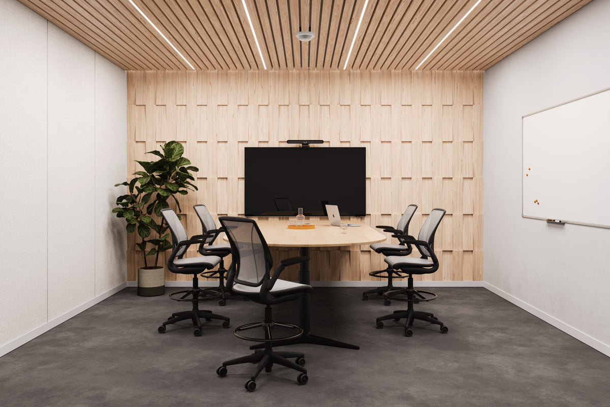 Five black Humanscale World One task stools with mesh backs, adjustable arms, and high cylinders with footrings, arranged around a large wooden conference table in a modern office