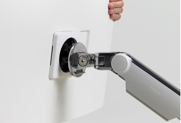 Monitor Arm with a hand holding it on a white background