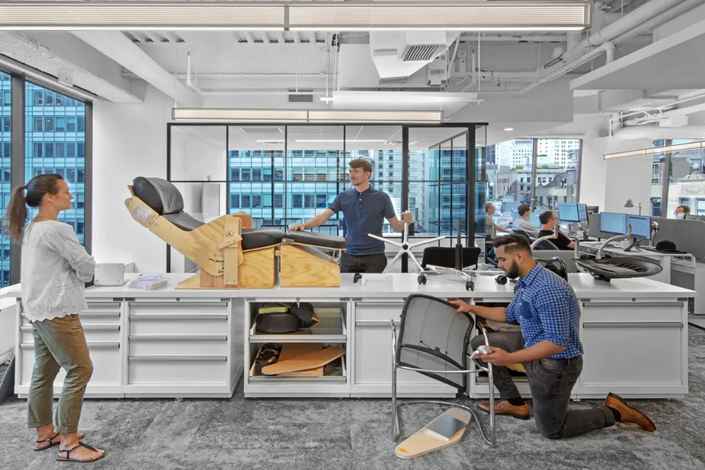 People working in a modern office with large windows